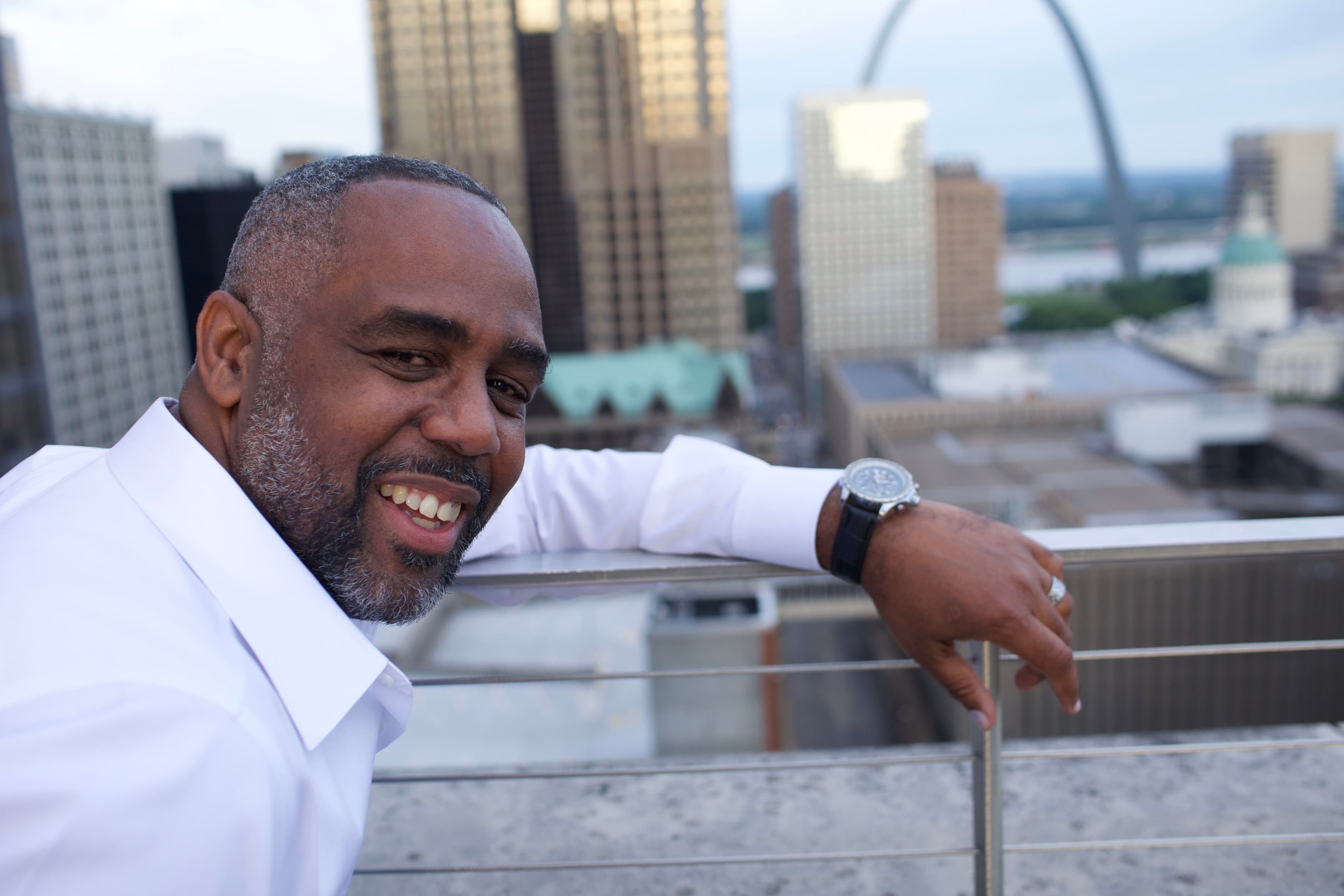 Darren L. Buckner, founder of Portal HomeHub, on a rooftop overlooking downtown St. Louis and the Gateway Arch